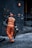 man in orange safety vest holding metal