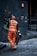 man in orange safety vest holding metal