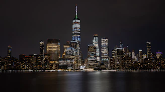 An elegant nighttime city skyline with illuminated skyscrapers reflecting ambition and success.