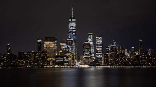 An elegant nighttime city skyline with illuminated skyscrapers reflecting ambition and success.