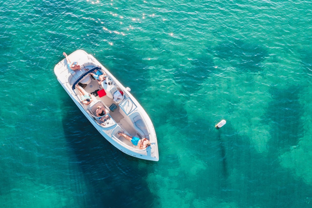 people on white boat