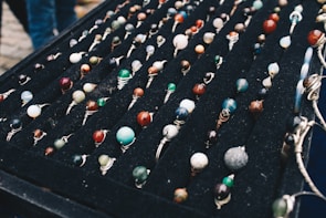 An elegant display of various gemstone rings arranged artistically.