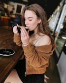 A serene scene of a woman enjoying coffee in a cozy cafe.