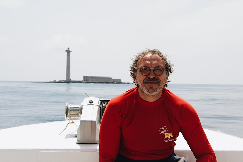 man in red wetsuit on boat bear island during daytime