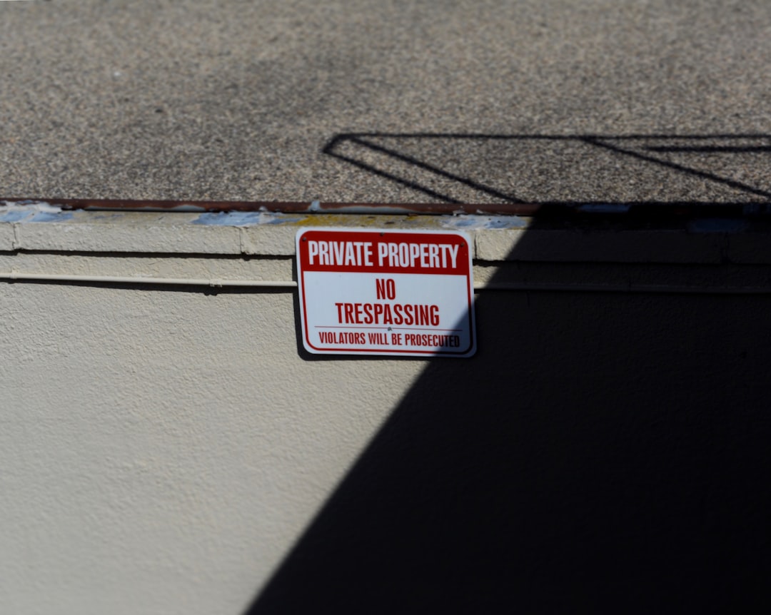 white and red Private Property No trespassing signboard,