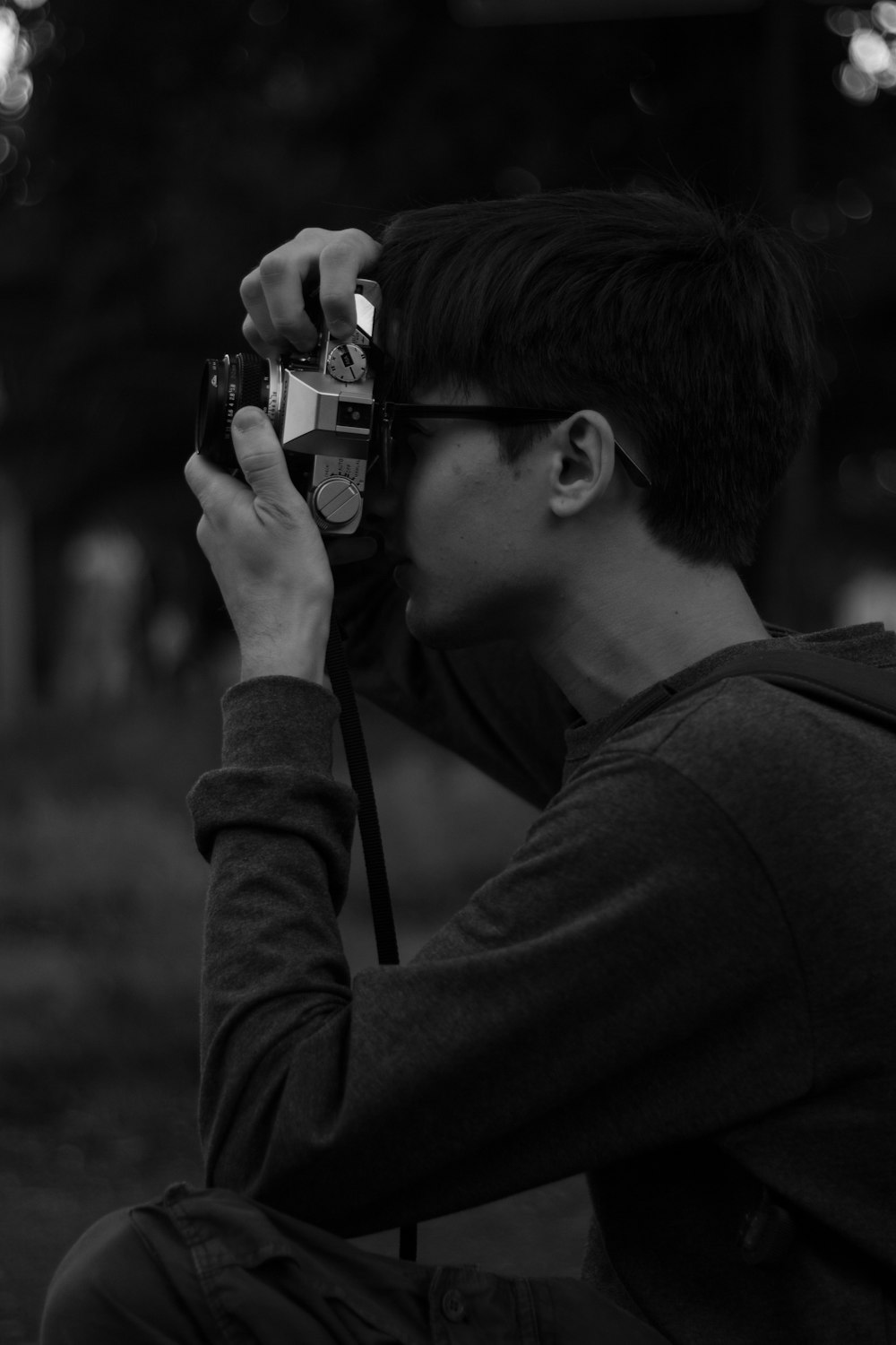 grayscale photography of man taking picture