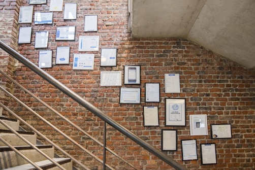 photos on wall near stairs