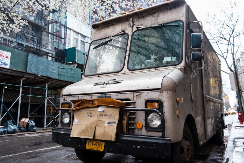 brown truck in road during daytime