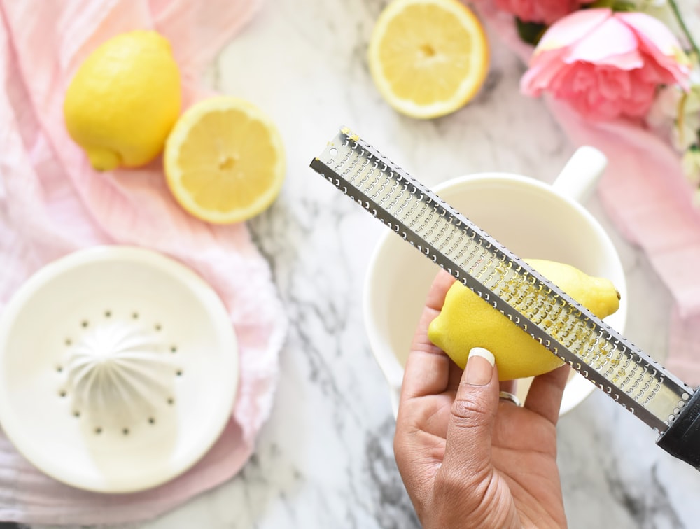 person slicing lemon