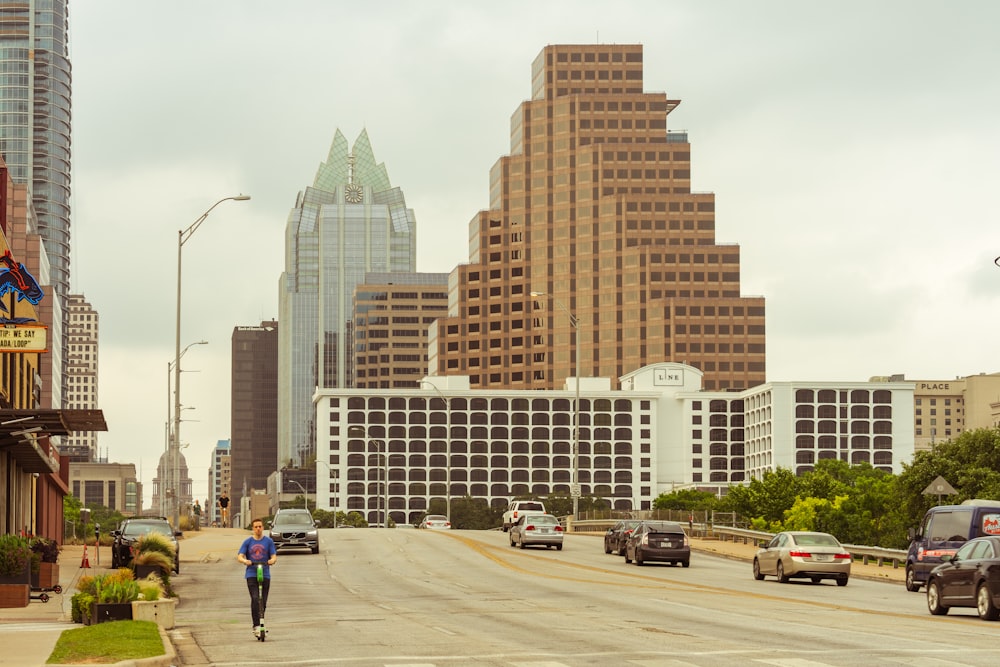 cars passing by buildings during daytime