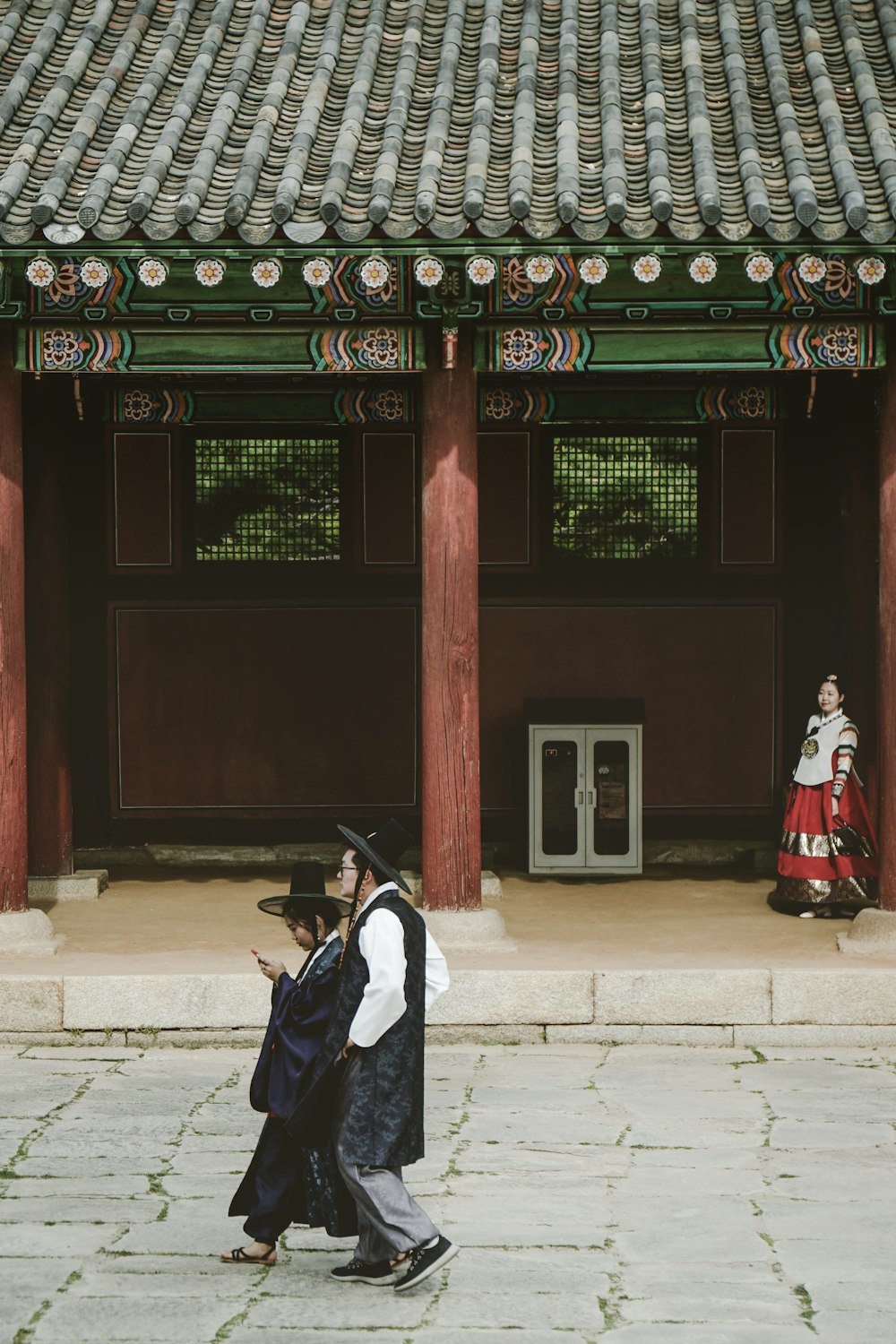 a couple of people that are standing in front of a building