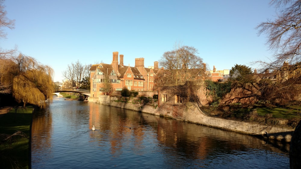 brown brick building along the river