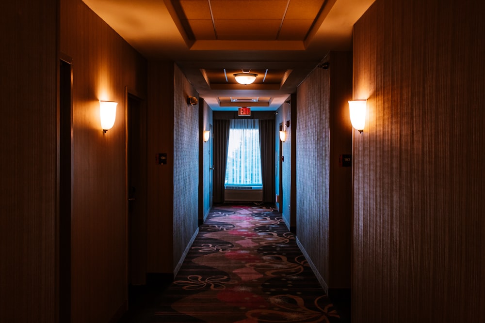 hallway of a hotel leading to a window