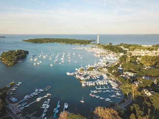 A serene aerial view of a pristine African island resort with luxury yachts docked at the marina.
