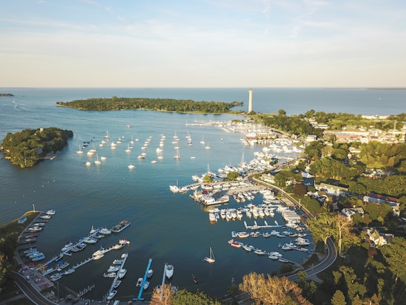 A serene aerial view of a pristine African island resort with luxury yachts docked at the marina.