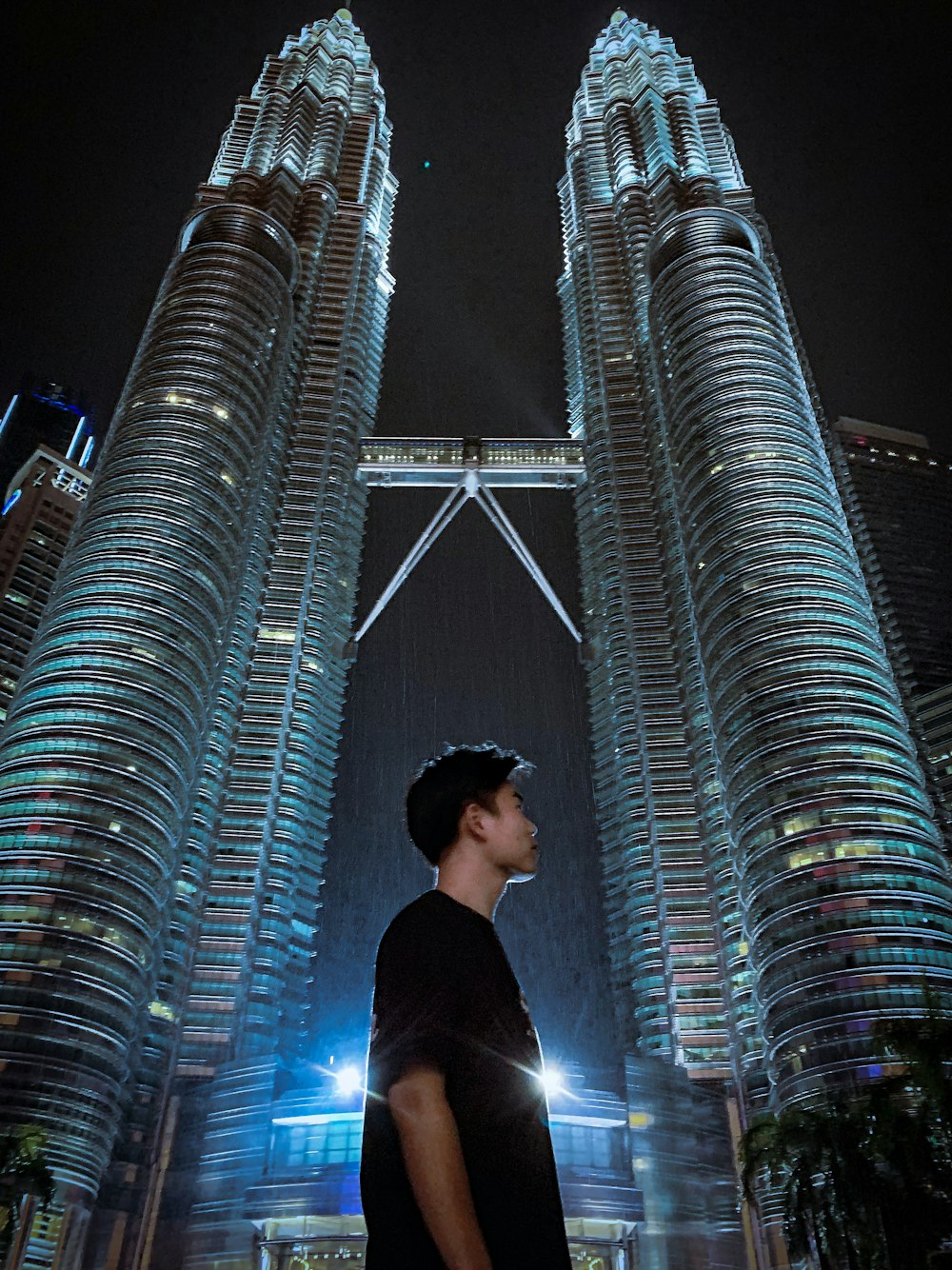 man standing near Petronas Tower