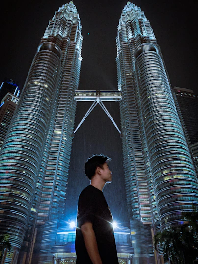 man standing near Petronas Tower