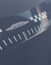 Close-up of a rally car dashboard with Sebastien Ogier's signature visible.