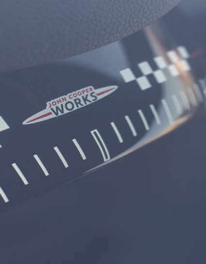 Close-up of a black and white t-shirt featuring a bold tachometer graphic.