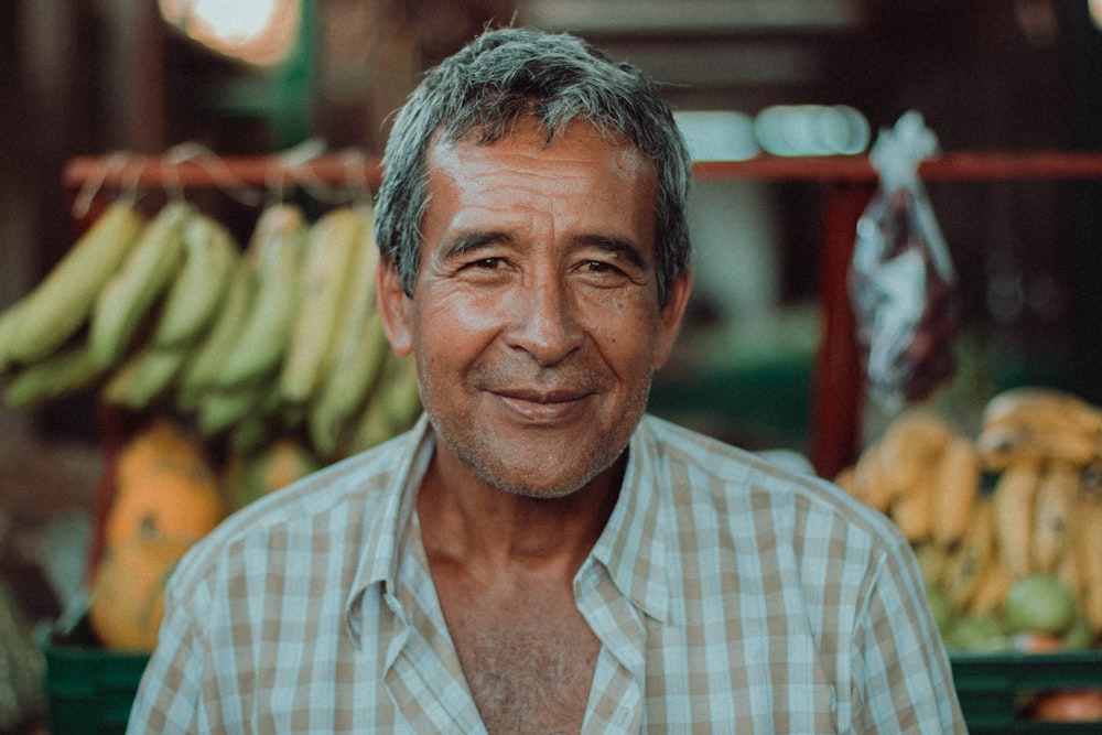 man wearing white and brown checked sport shirt