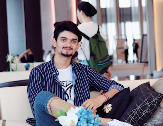 A relaxed setting showing a man lounging comfortably at home wearing Manmera's modern and trendy outfit