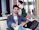A smiling young man casually sitting in a cozy urban apartment.