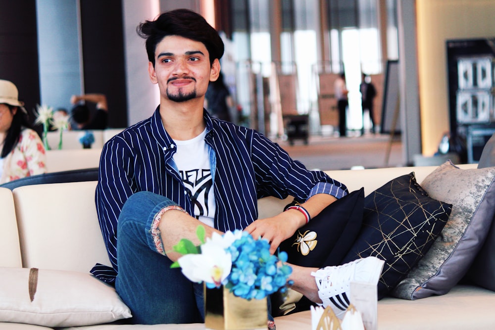 man sitting on sofa with crossed legs