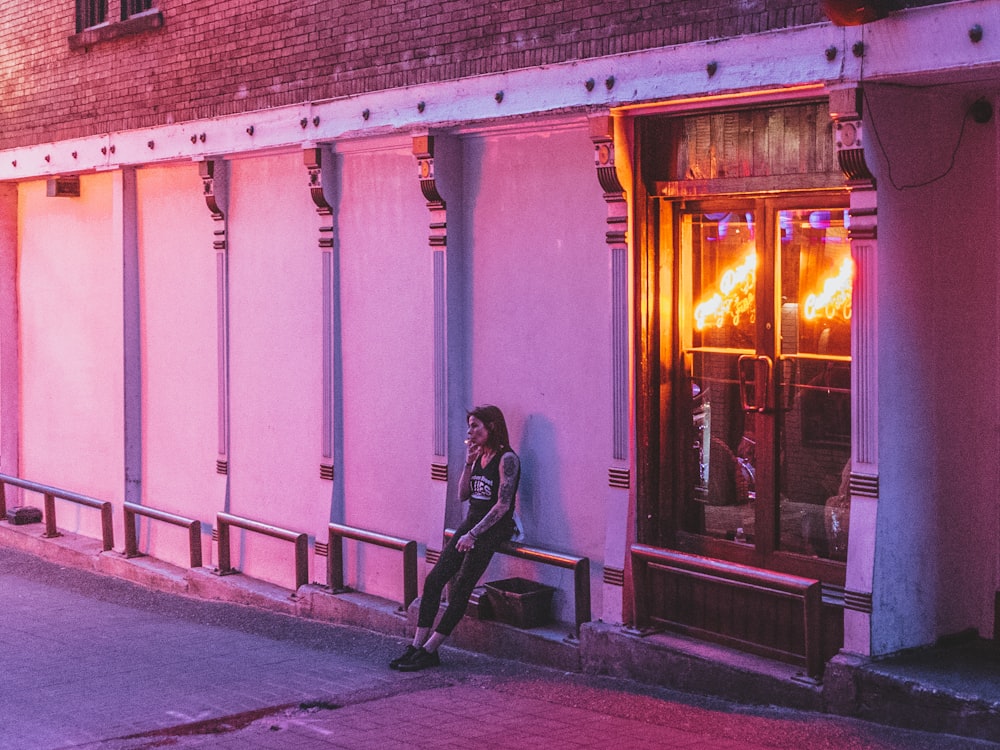 woman sitting down on railings