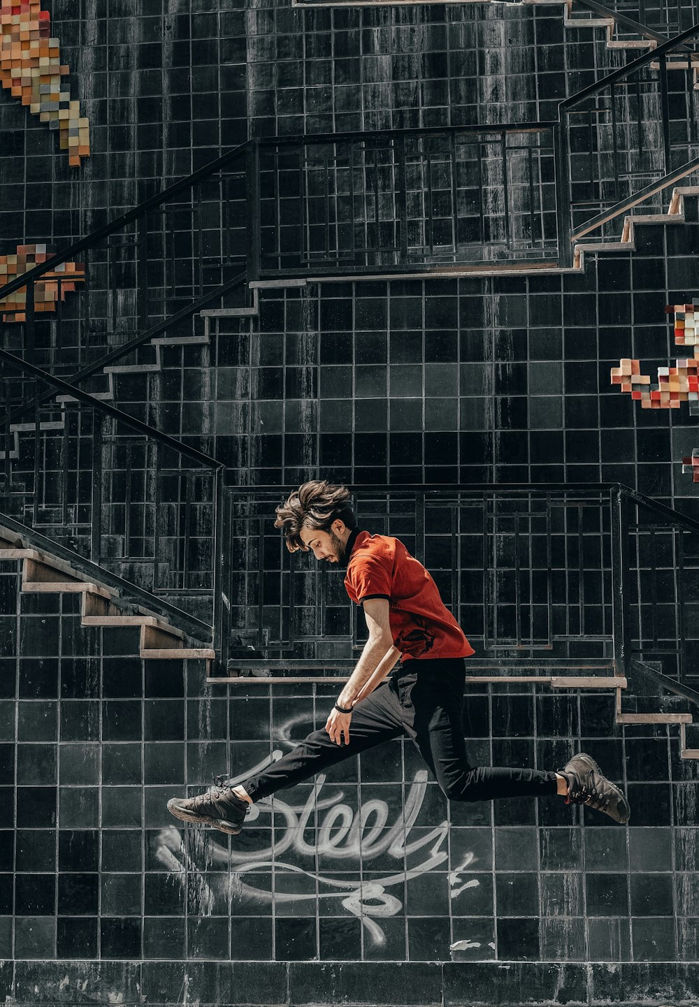 man jumping in front of building