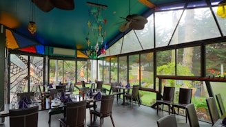 A beautifully arranged dining area with tropical decor and a view of the garden.