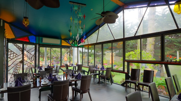 A beautifully arranged dining area with tropical decor and a view of the garden.