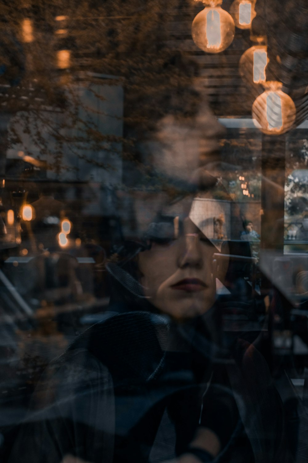 woman standing behind clear glass