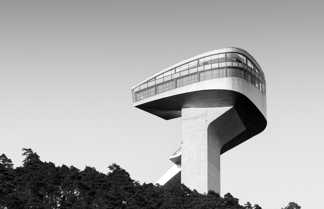 grayscale photography of concrete building near trees