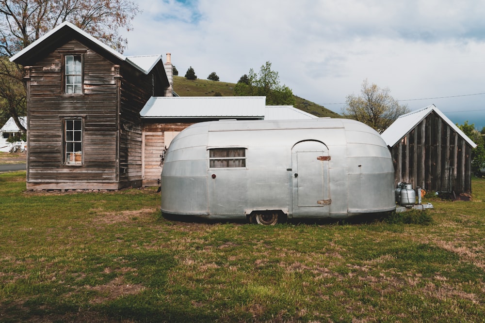 gray enclosure trailer near house