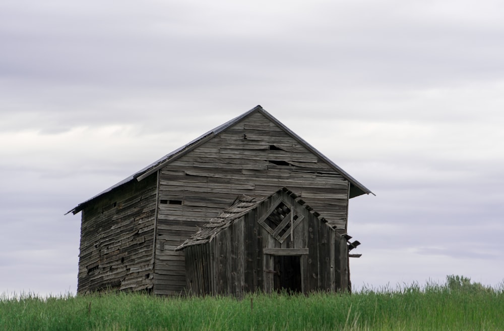 gray wooden barn under gray sky