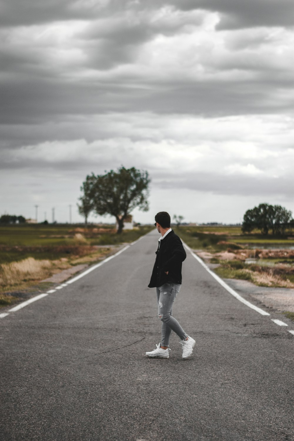 person standing on road