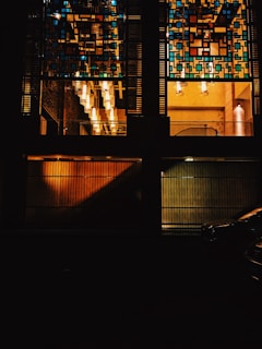Charming townhouse facade with geometric Moroccan patterns and warm gold lighting at dusk.