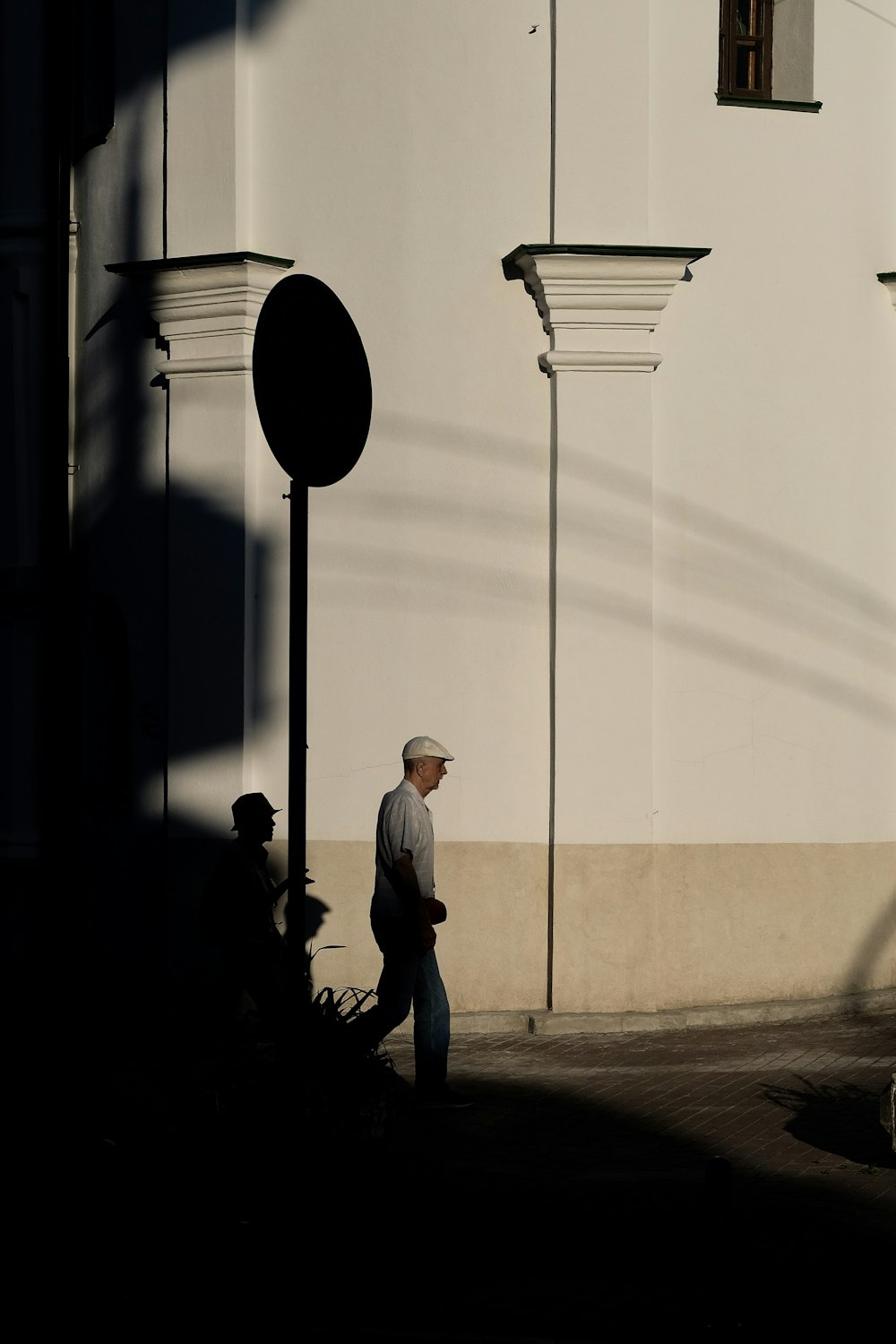 man walking on road during daytime