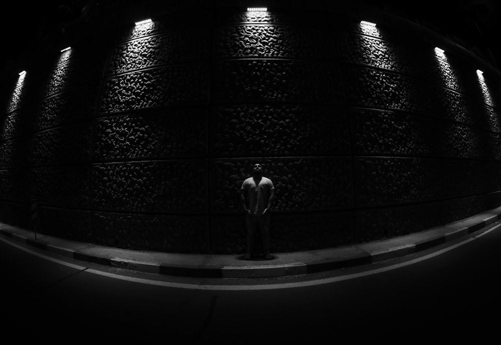 grayscale photo of man in subway