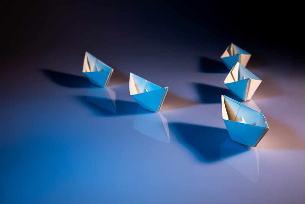 white paper boats on white surface