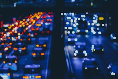 a city street filled with lots of traffic at night