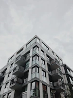 Modern residential apartment building with clean lines and large windows.