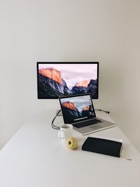 Minimalist workspace with a sleek laptop and a cup of coffee on a clean white desk.