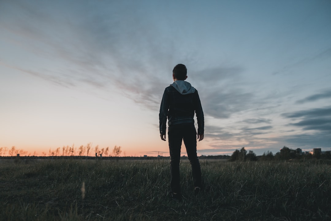 man standing in green grass