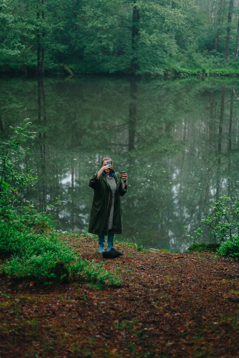 person standing beside body of water