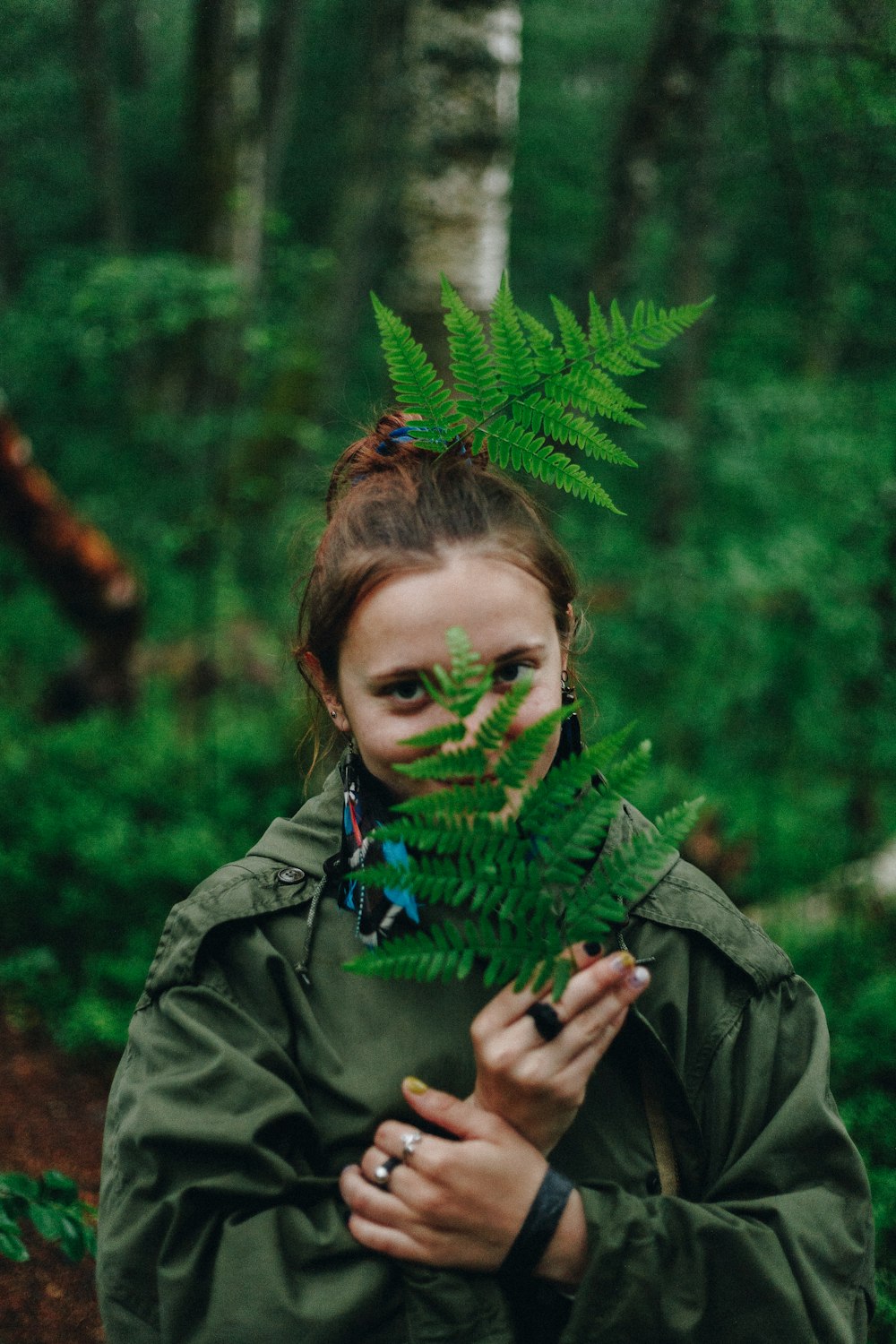 girl holding fern plant