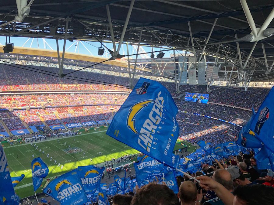 Packed football stadium with fans waving national flags during an international match