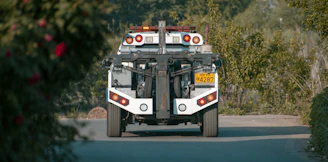 A heavy-duty tow truck lifting a vehicle in an urban setting