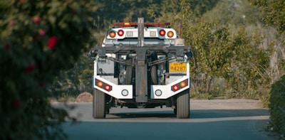 A powerful tow truck in action, lifting a heavy vehicle.