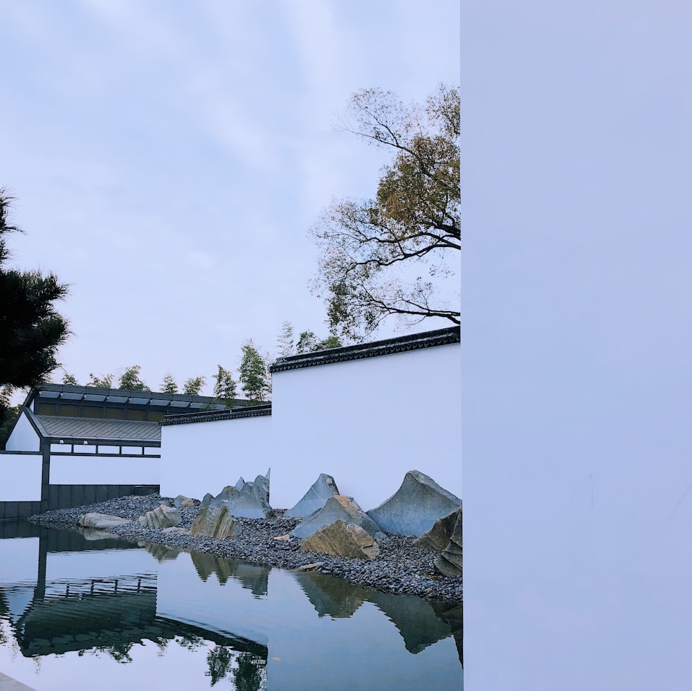 white and brown concrete house beside body of water